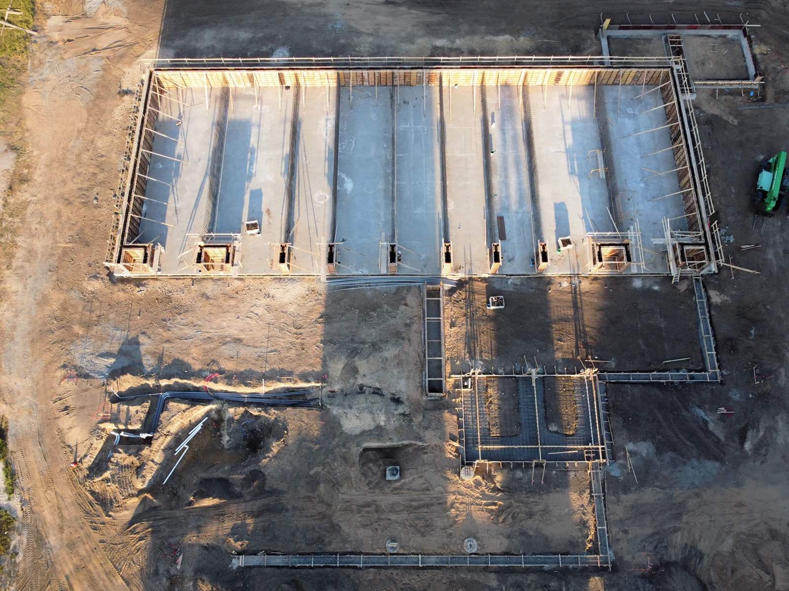 Aerial view of foundation formwork and footing trenches laid out on a cleared building site